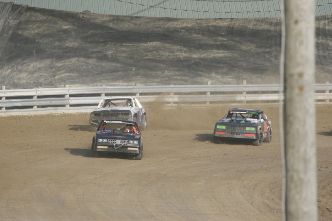 3 Race cars taking a turn at the Little Valley Speedway