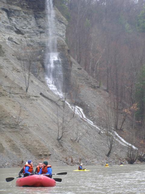 Groups Rafting near a small waterfall