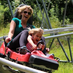 Woman & daughter on Mountain Coaster at Holiday Valley Resort in warm weather