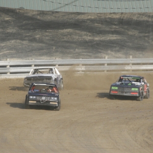 3 Race cars taking a turn at the Little Valley Speedway