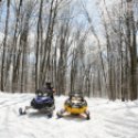 Two snowmobiles in a turn